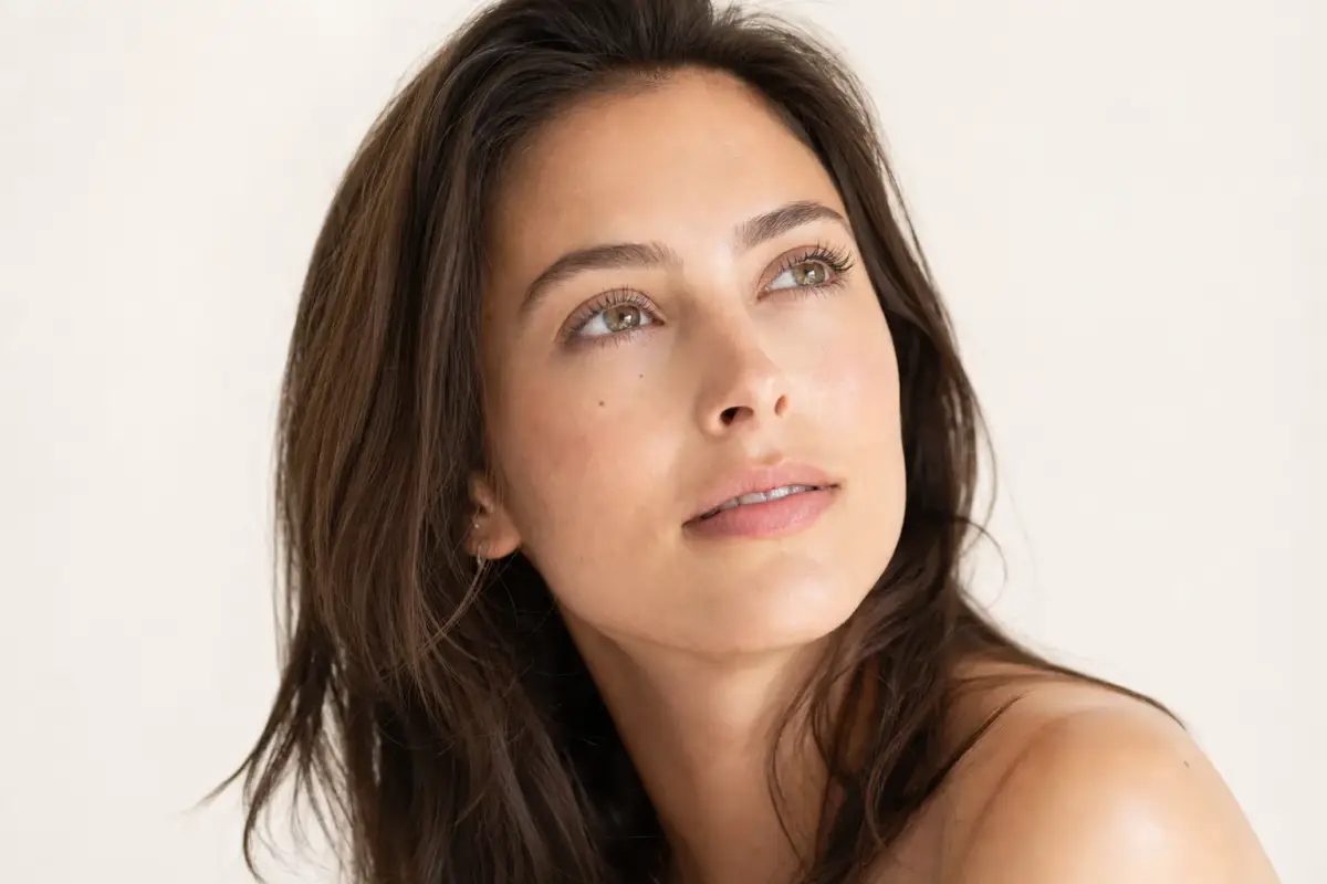 Woman in her late twenties with smooth skin and a natural expression