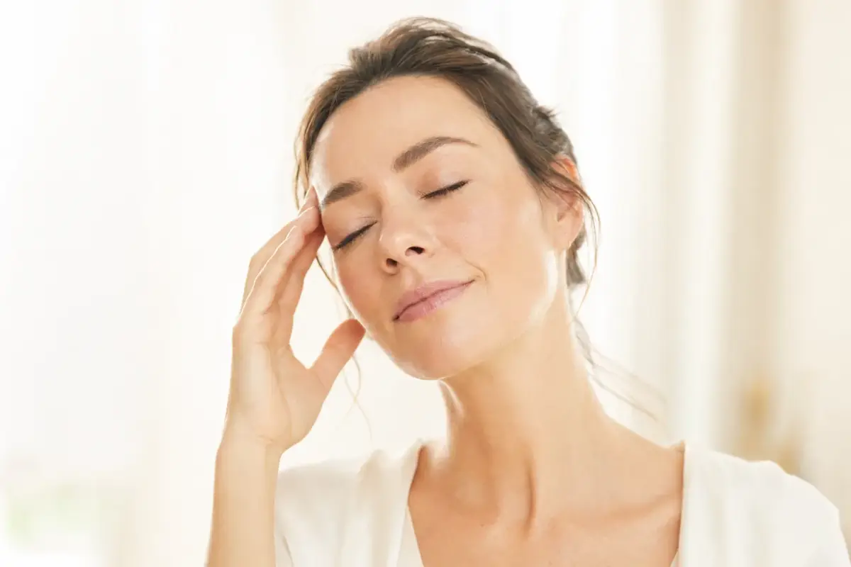 Woman in her thirties with eyes closed and calm relaxed expression