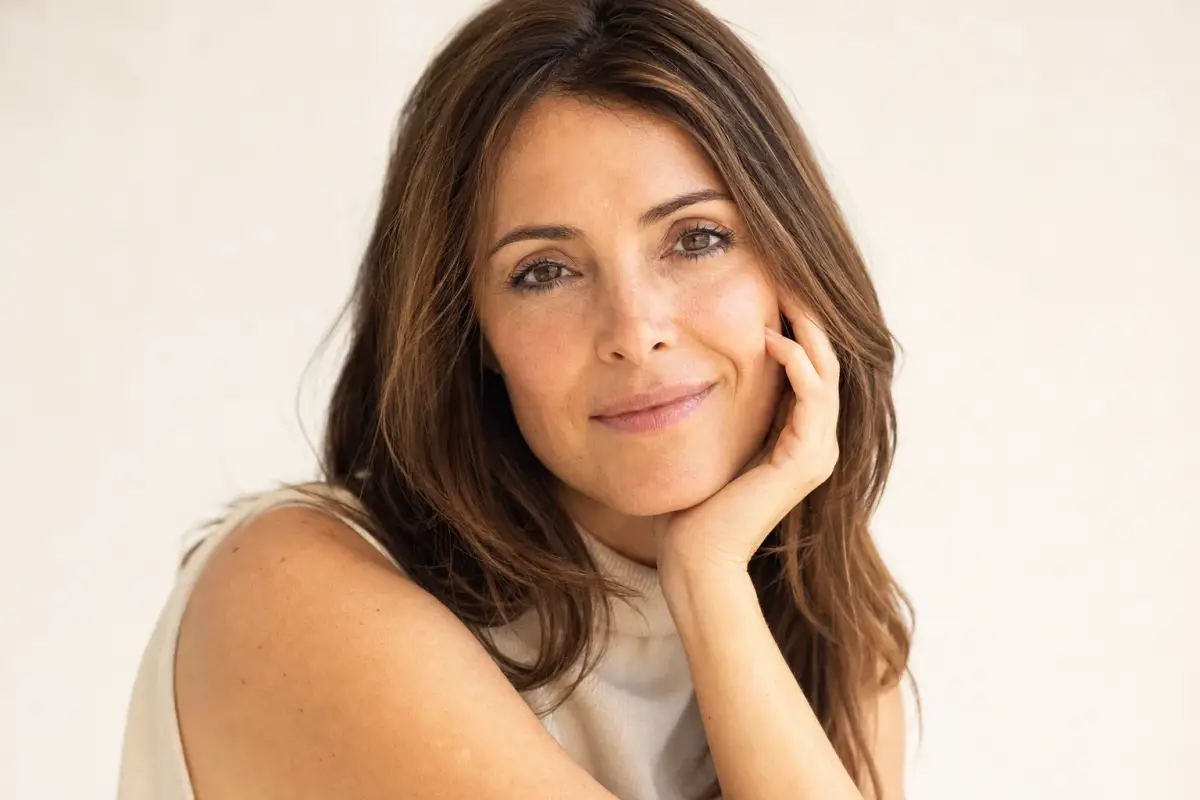 Woman in her late thirties with a relaxed smooth brow and expressive eyes