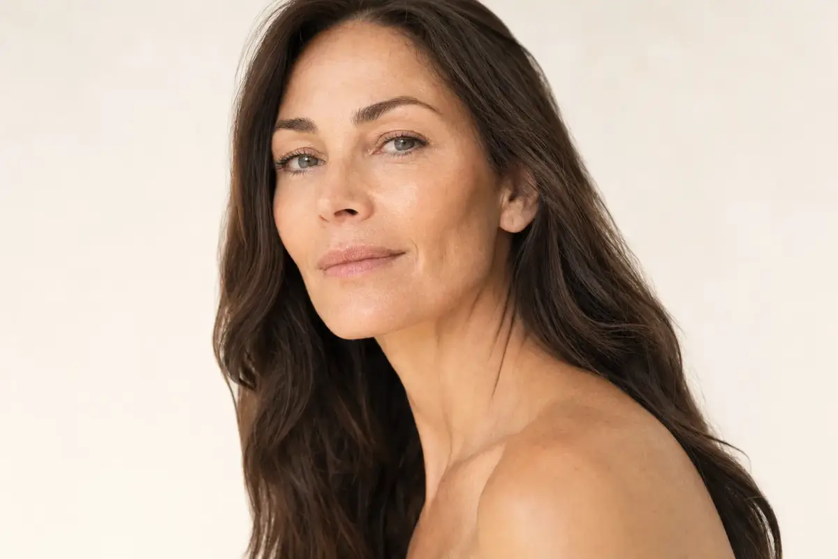 Woman in her forties three-quarter view with a defined sharp jawline and long neck