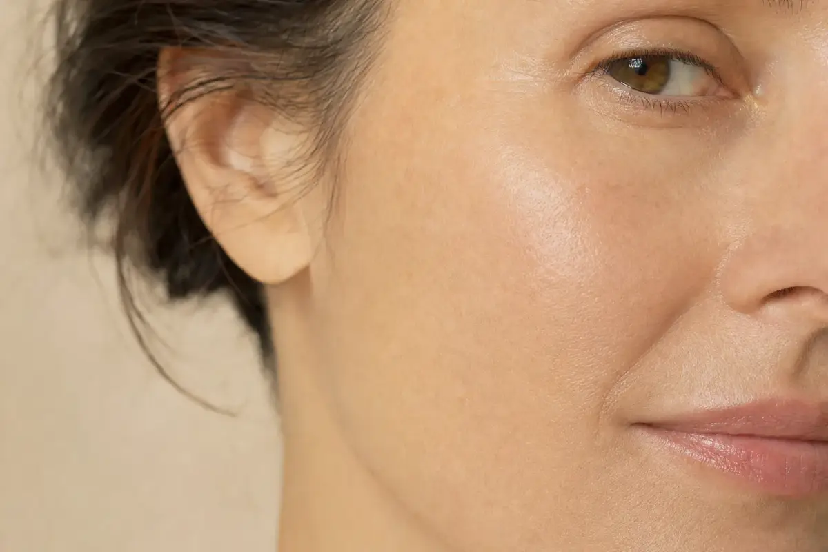 Close-up of plump healthy skin on the cheek of a woman in her forties