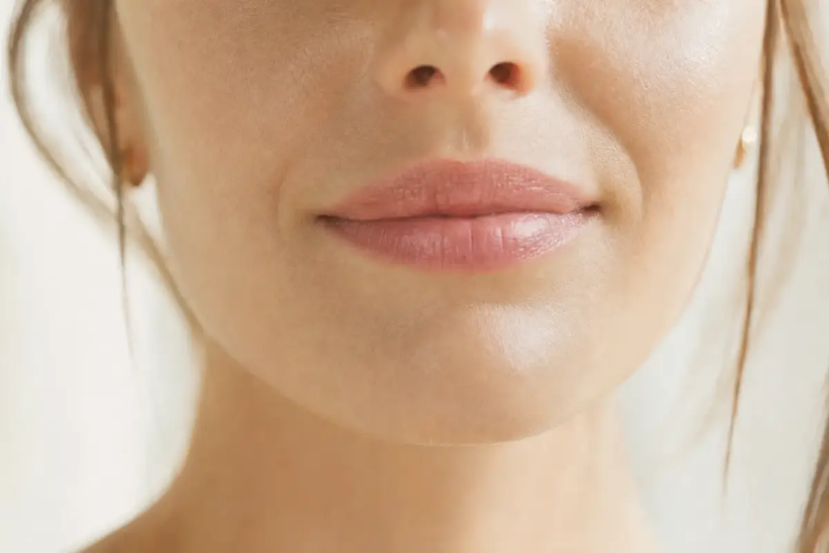 Close-up of natural full lips of a woman in her thirties