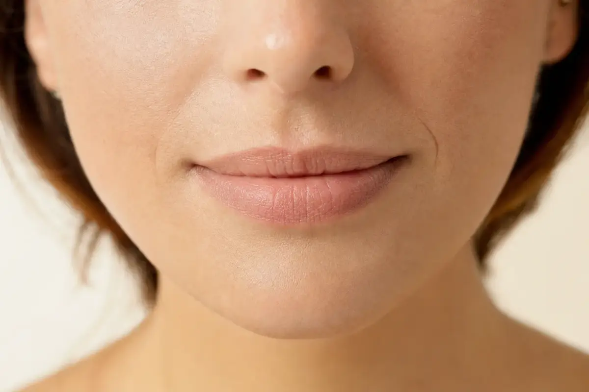 Close-up of soft natural lips of a woman in her thirties