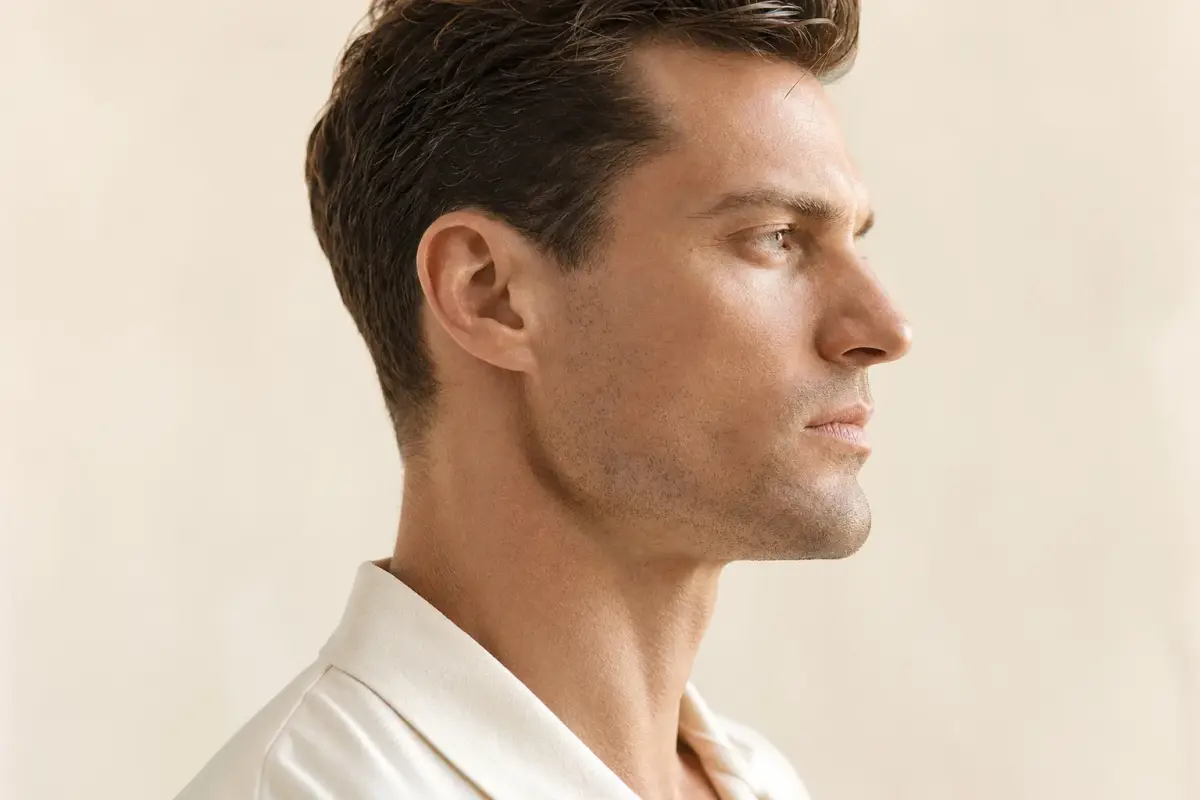 Side profile of a man in his thirties with a sharp defined jawline