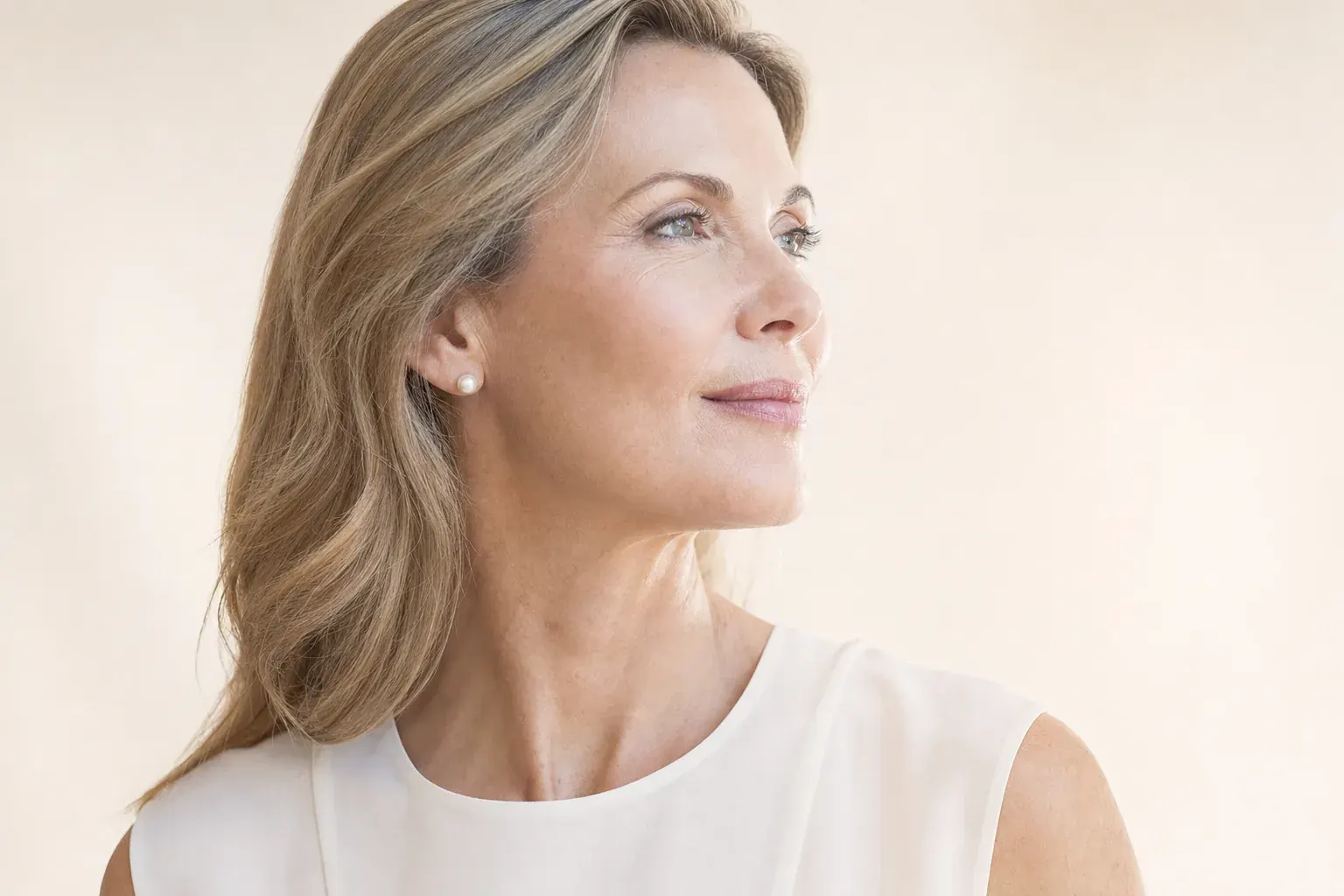 Woman in her late forties in profile turning toward the light
