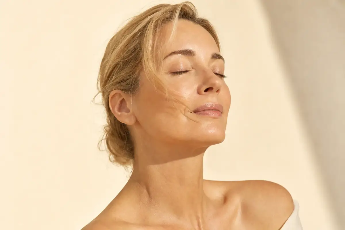 Woman in her forties with tight smooth lower face and glowing skin