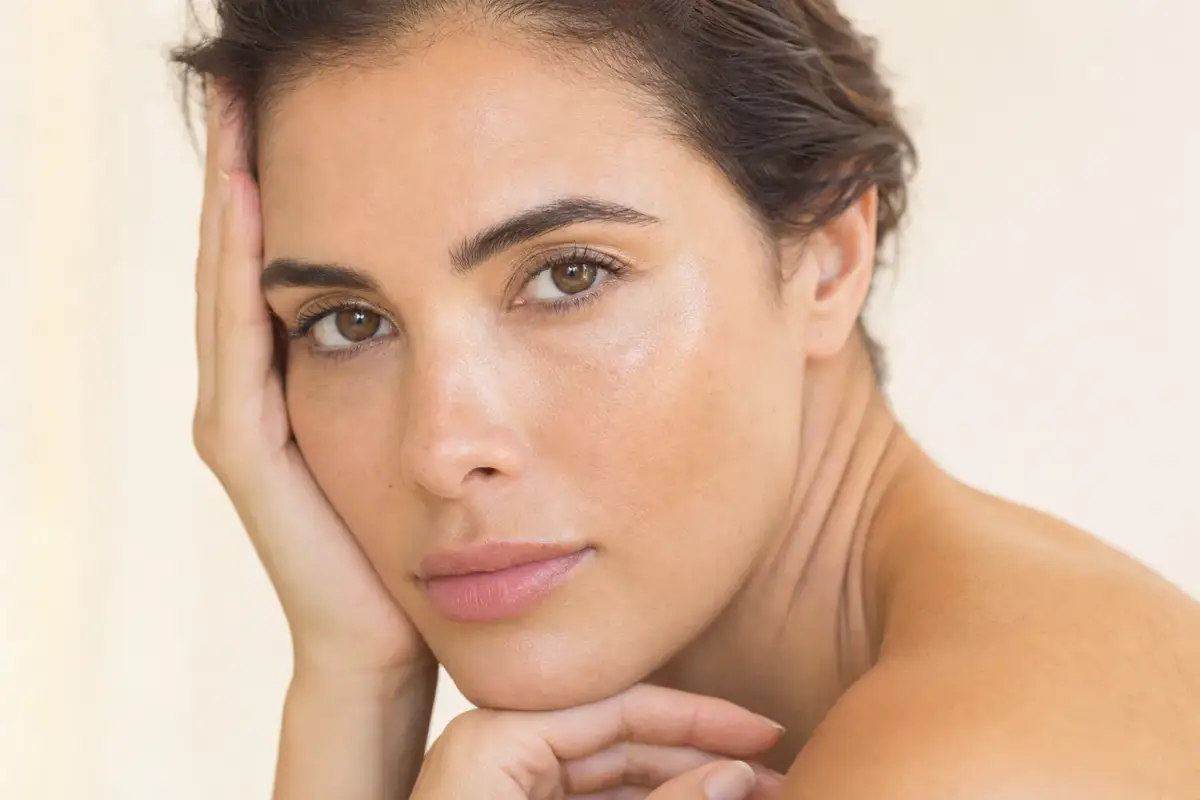 Close-up of a woman in her thirties with clear radiant skin