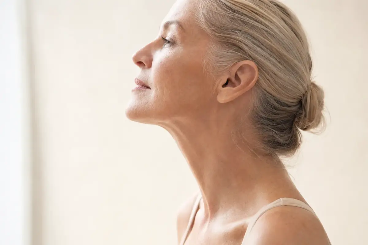 Side profile of a woman in her fifties with smooth firm neck
