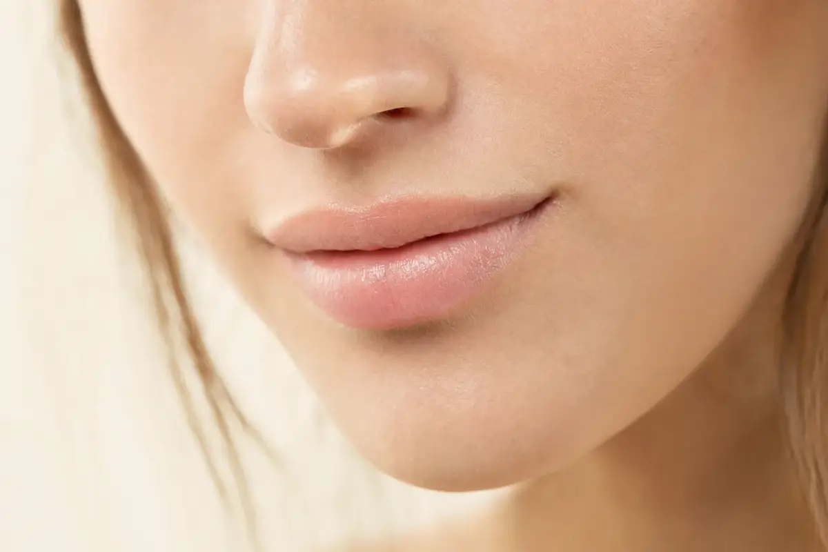 Close-up of soft natural lips of a woman in her late twenties